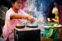 Local woman preparing street food.